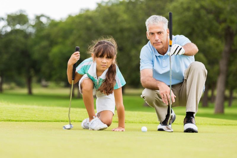 Father and daughter playing golf in Woodfield Country Club