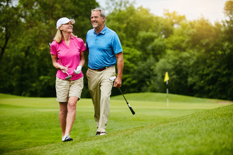 A happy couple playing golf in Woodfield Country Club, Boca Raton